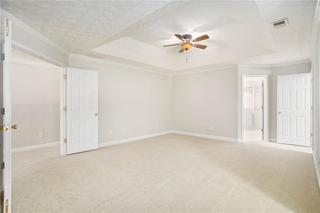 carpeted empty room featuring ceiling fan, a textured ceiling, and ornamental molding