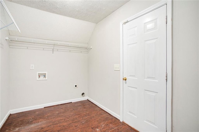 laundry area with hookup for a washing machine, hookup for an electric dryer, dark hardwood / wood-style flooring, and a textured ceiling