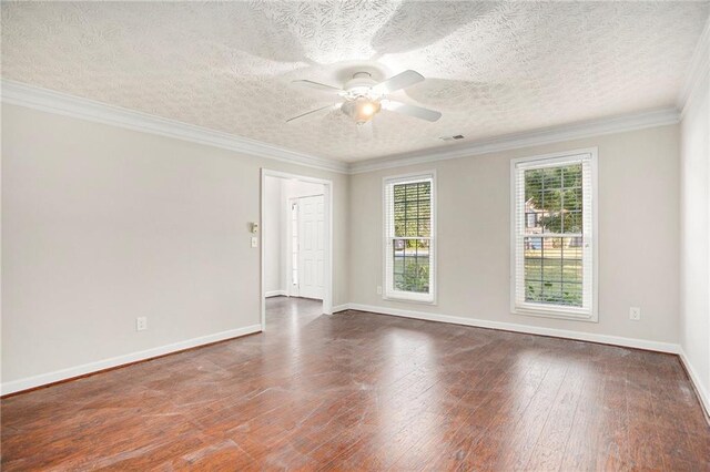 empty room featuring dark wood-type flooring, ceiling fan, crown molding, and a textured ceiling