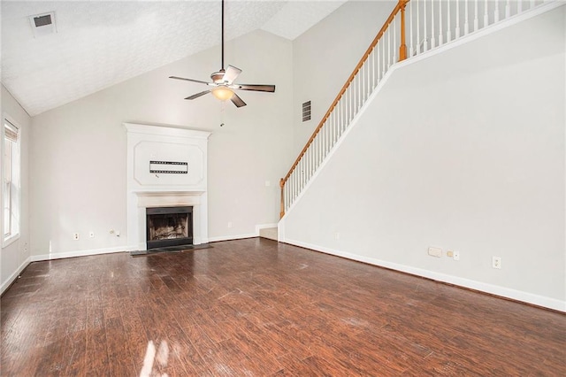 unfurnished living room featuring a textured ceiling, high vaulted ceiling, hardwood / wood-style floors, and ceiling fan