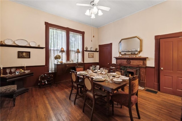 dining area featuring ceiling fan and dark wood-type flooring