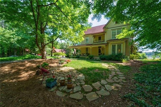 view of yard featuring covered porch