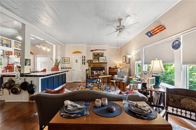 living room featuring hardwood / wood-style floors, wooden ceiling, ceiling fan, ornamental molding, and built in shelves