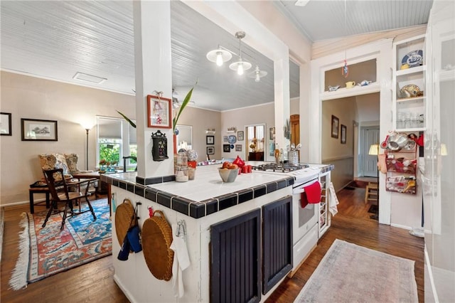 kitchen with decorative light fixtures, dark wood-type flooring, tile countertops, and white stove