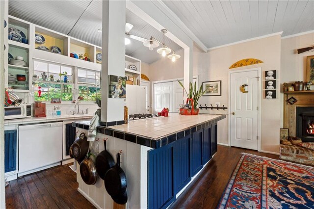 kitchen featuring tile counters, white appliances, dark hardwood / wood-style flooring, blue cabinets, and hanging light fixtures