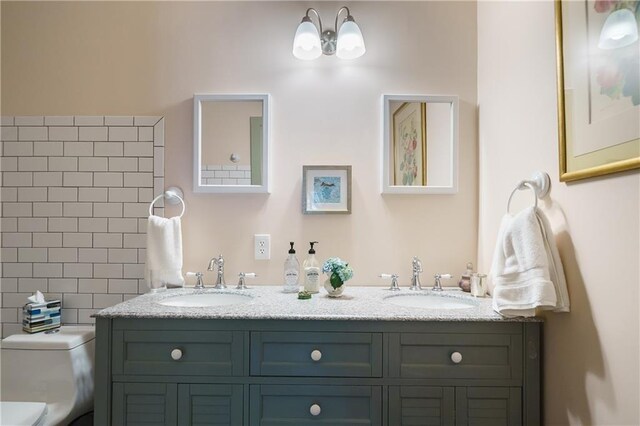 bathroom featuring toilet and vanity