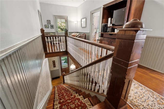 staircase with hardwood / wood-style flooring