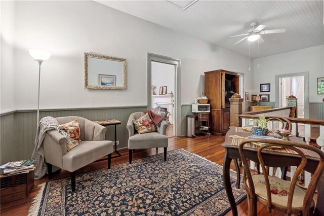 sitting room featuring ceiling fan and hardwood / wood-style floors