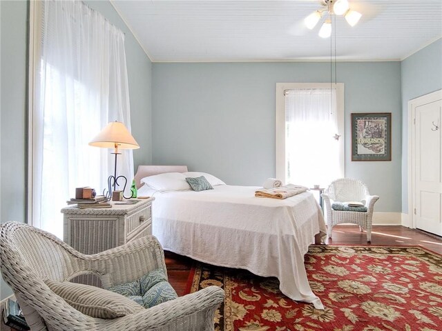 bedroom featuring ceiling fan and dark hardwood / wood-style floors