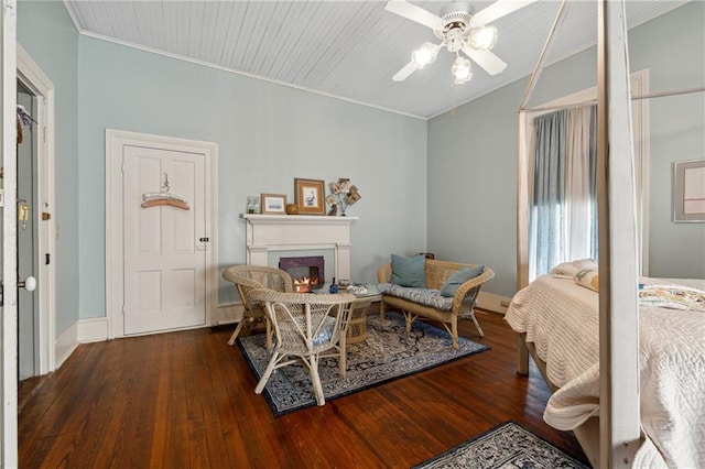 living area featuring ceiling fan and dark hardwood / wood-style flooring