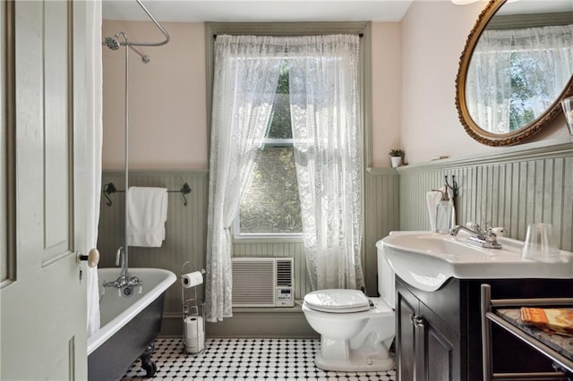 full bathroom featuring toilet, a wall unit AC, tile patterned flooring, shower / bathtub combination, and vanity