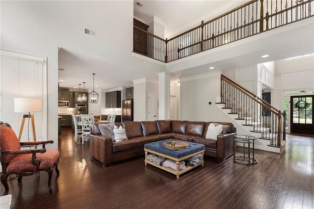 416 Battlefield Creek Dr, Marietta, GA 30064 - living room with a high ceiling, stairway, dark wood-style flooring, decorative columns, and ornamental molding