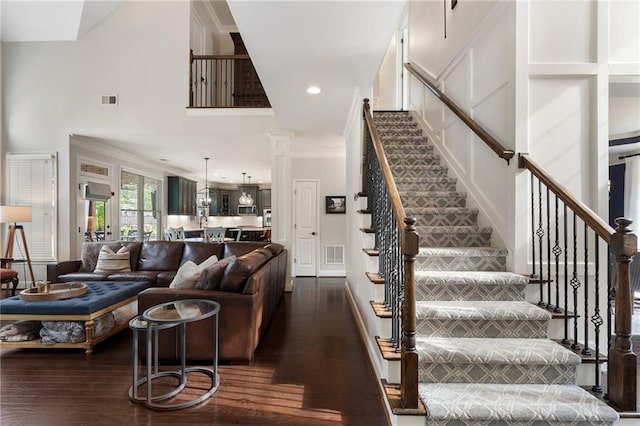 416 Battlefield Creek Dr, Marietta, GA 30064 - living room with stairs, dark wood-style floors, ornamental molding, a towering ceiling, and ornate columns
