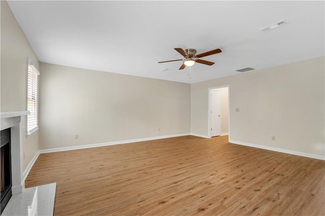 1368 Poplar Pointe SE, Smyrna, GA 30082 - unfurnished living room featuring a high end fireplace, ceiling fan, light wood-style flooring, and baseboards