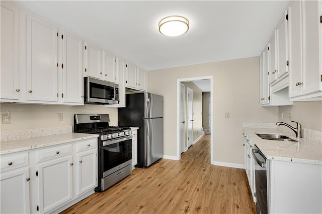 1368 Poplar Pointe SE, Smyrna, GA 30082 - kitchen with stainless steel appliances, a sink, light wood finished floors, and white cabinetry