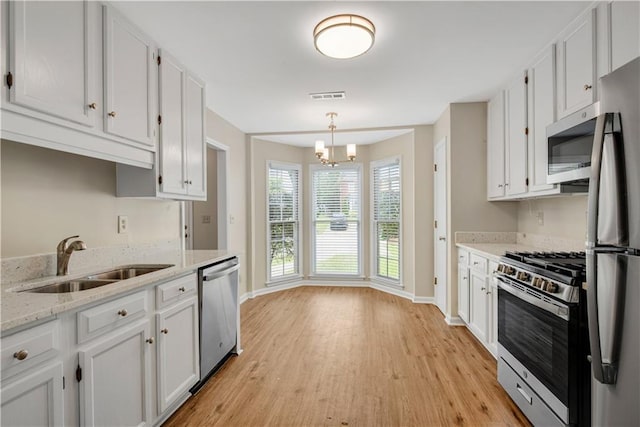 1368 Poplar Pointe SE, Smyrna, GA 30082 - kitchen with stainless steel appliances, a sink, baseboards, and light wood finished floors