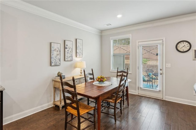 dining space with ornamental molding and dark hardwood / wood-style flooring