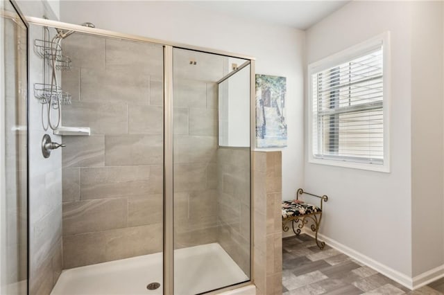 bathroom featuring a shower with door and hardwood / wood-style floors