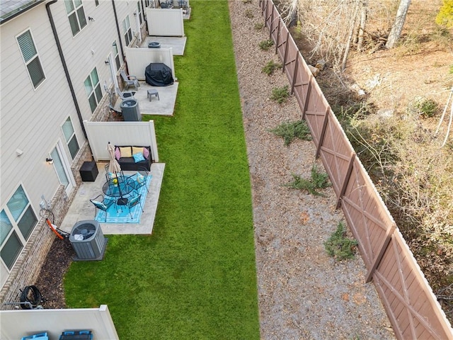 view of yard with central AC unit and a patio