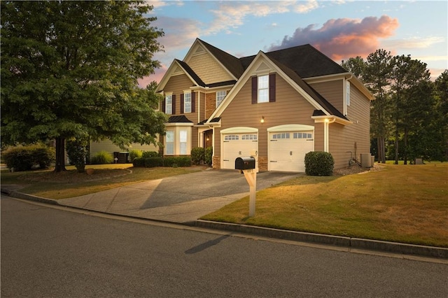 craftsman inspired home with a garage, cooling unit, and a lawn