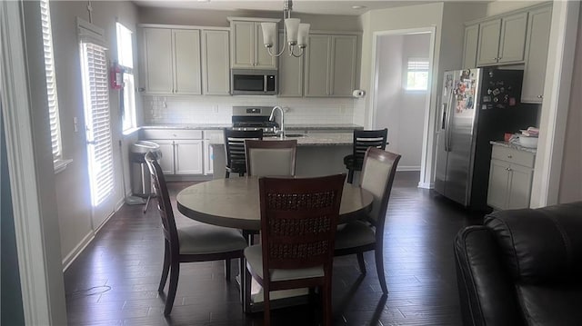 3750 Richmond Bnd, Lithonia, GA 30038 - kitchen with stainless steel appliances, healthy amount of natural light, backsplash, and an island with sink