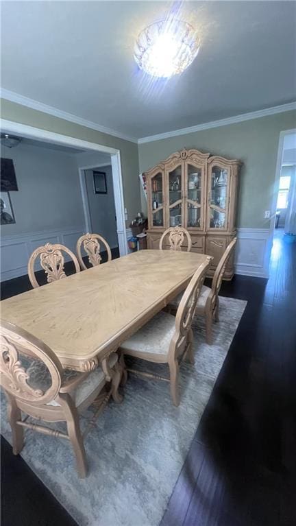 3750 Richmond Bnd, Lithonia, GA 30038 - dining area featuring ornamental molding, a wainscoted wall, a decorative wall, and dark wood-type flooring