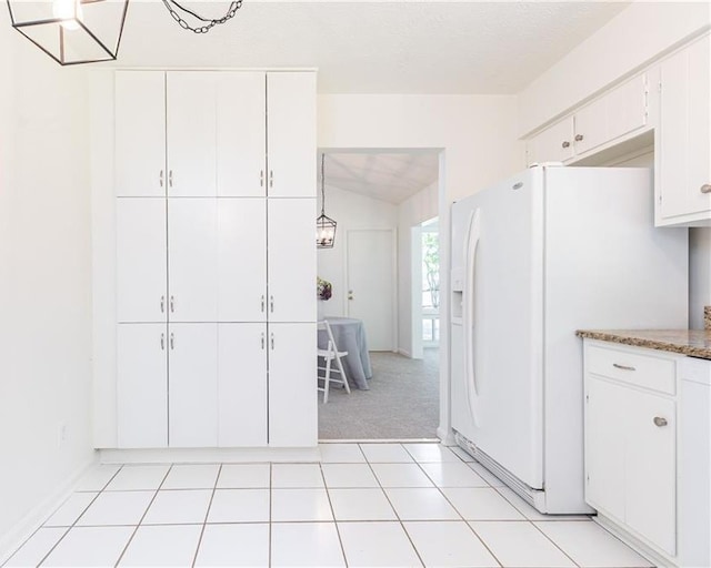 2753 Fireside Ct SE, Marietta, GA 30067 - kitchen with white refrigerator with ice dispenser, white cabinetry, light colored carpet, and lofted ceiling