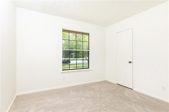 2753 Fireside Ct SE, Marietta, GA 30067 - spare room featuring light carpet and baseboards