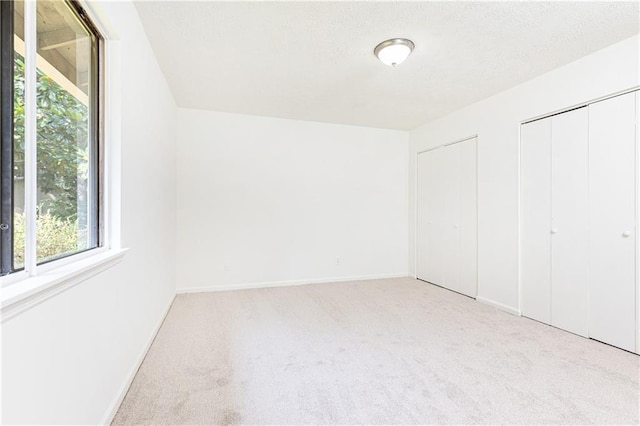2753 Fireside Ct SE, Marietta, GA 30067 - unfurnished bedroom with carpet flooring, multiple windows, and baseboards