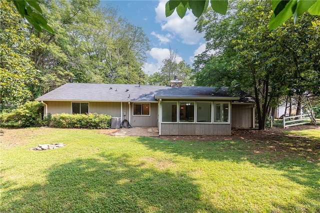 2753 Fireside Ct SE, Marietta, GA 30067 - rear view of house with a chimney and a sunroom