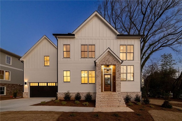 modern farmhouse style home featuring an attached garage, board and batten siding, and concrete driveway