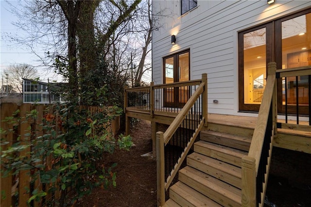 deck featuring stairway and fence