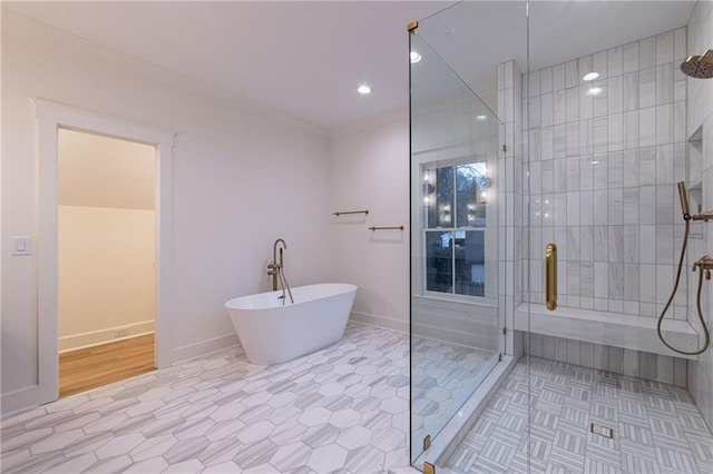 bathroom with baseboards, tile patterned floors, a freestanding bath, a shower stall, and recessed lighting