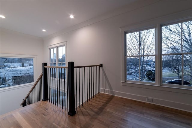 hallway with crown molding, recessed lighting, an upstairs landing, wood finished floors, and baseboards