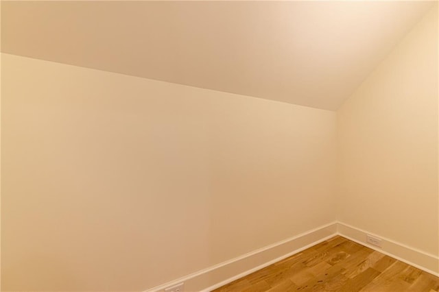 interior space featuring baseboards and wood finished floors