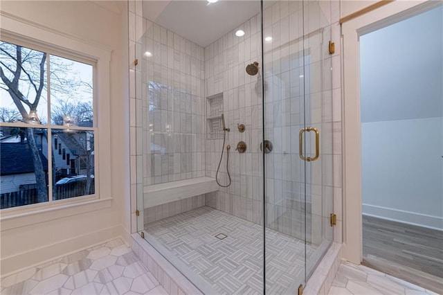 full bathroom with tile patterned floors, a shower stall, and baseboards