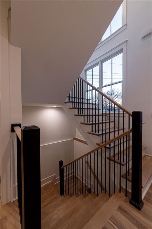 stairs featuring wood finished floors