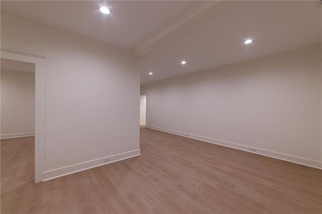 unfurnished room featuring baseboards, crown molding, wood finished floors, and recessed lighting