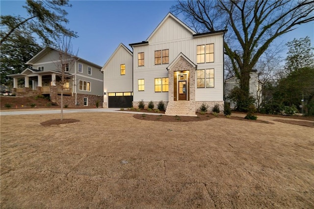 modern inspired farmhouse with a garage, concrete driveway, and board and batten siding