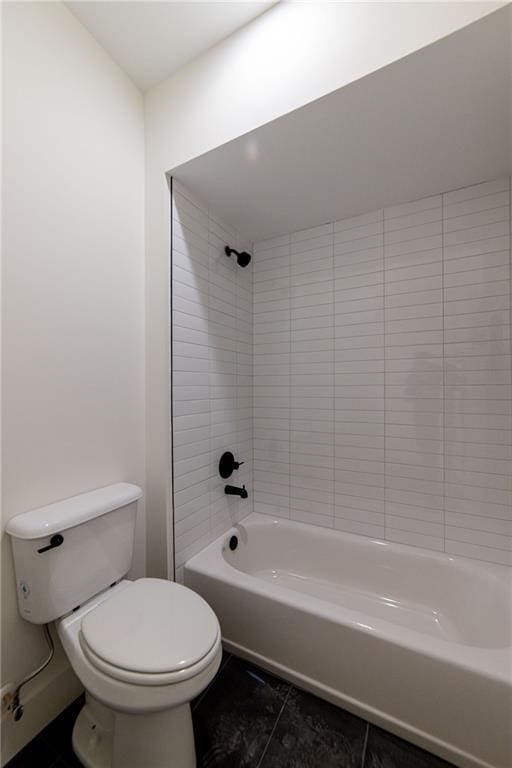 bathroom featuring shower / bathing tub combination, toilet, and tile patterned floors