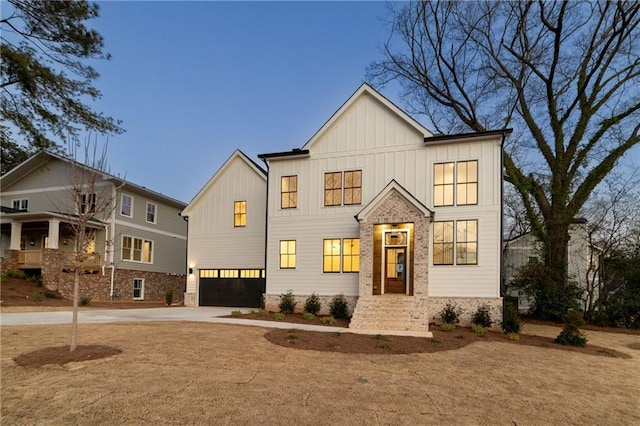 modern farmhouse style home featuring an attached garage, board and batten siding, and concrete driveway