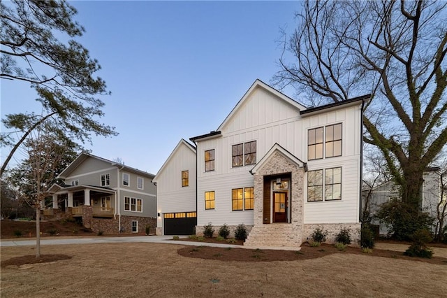 modern farmhouse with board and batten siding, driveway, and a garage