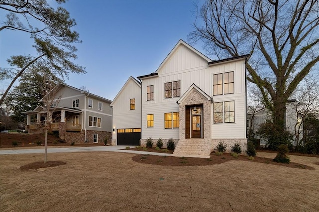 modern farmhouse style home featuring board and batten siding, driveway, and an attached garage