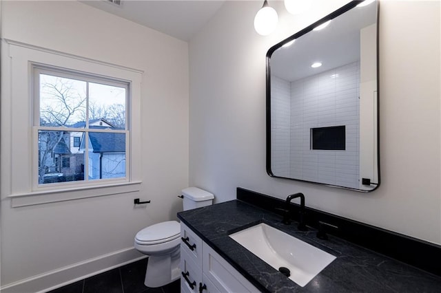 bathroom with tile patterned flooring, vanity, toilet, and baseboards