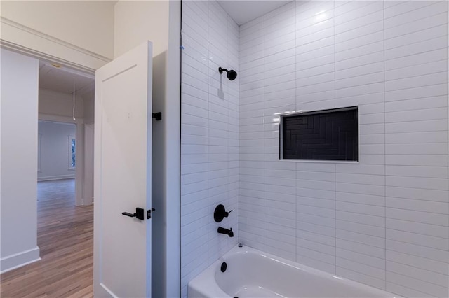 full bath featuring baseboards, shower / tub combination, and wood finished floors