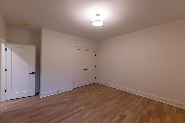 spare room with wood finished floors and baseboards