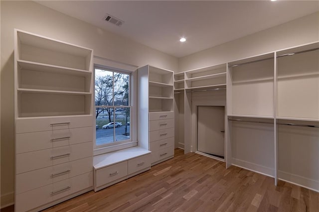 walk in closet featuring light wood finished floors and visible vents