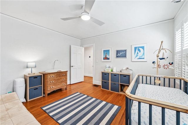 bedroom featuring a ceiling fan and wood finished floors