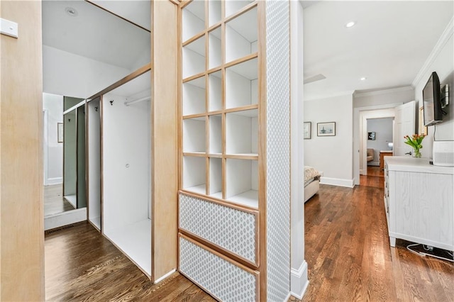 hallway with ornamental molding, baseboards, recessed lighting, and wood finished floors