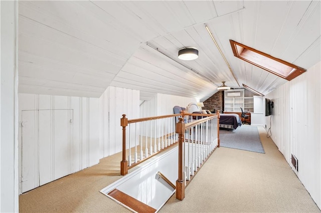 bonus room featuring carpet flooring, vaulted ceiling, and wood walls